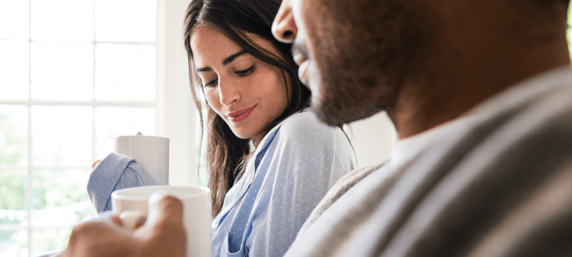 Woman and Man Drink coffee, enjoying clean air from a HealthWay Air Purifier